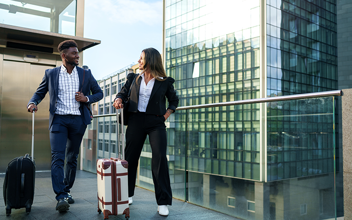 Man and woman walking with suitcases 